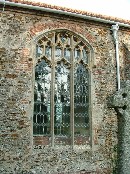 red brick surrounded windows in carstone walls