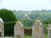 a windmill turning lazily in the valley below