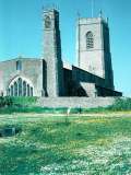 A picture by Tom of St Nicholas in the late 1960s, his children in the foreground