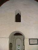 triangular headed window above tower arch