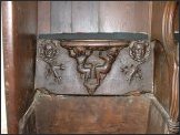 seated figures support the seat