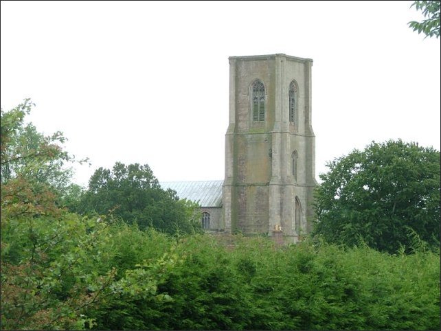 St Agnes - an austere giant among early summer trees.