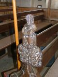 Bench end: figure with an open book