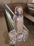 Bench end: Angel with a chrism chest