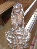 Bench end: grotesque figure reading