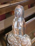Bench end: female figure