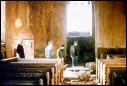 Roger Last showing the Harrods around Corpusty church, 1974