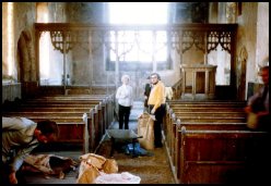 Roger Last showing the Harrods around Corpusty church, 1974