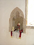 a sign of modern devotional life in an old piscina