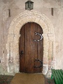 north doorway, weathered despite the porch