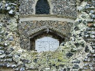 war memorial through the ruined chancel east window