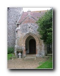 The porch with an 18th century font acting as a bird bath
