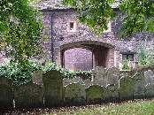 15th century churchyard entrance - now screened by reset gravestones