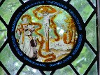 Flemish glass: a crucifixion scene attended by vestmented figures in the bottom left hand corner
