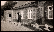 The Reverend Bradford standing outside the Rectory, 1930s: more lions