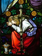 Mary of Magdala weeps at the foot of the cross