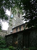 set back behind mature trees, tight in its little graveyard