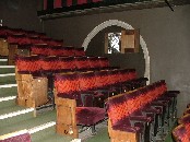 inside the auditorium, the top of a 15th century window on the north side protruding