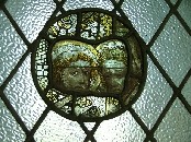 panel of medieval glass in the window between porch and aisle