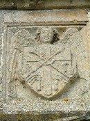 angel holding shield with instruments of the passion