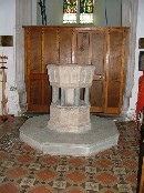 font, one of several local Purbeck marble fonts reset on a collonade