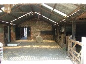 inside the barn, looking towards old flint walling