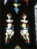 East window glass: armoured figures holding scourges