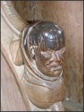 Head on the return stalls, polished by generations of hands