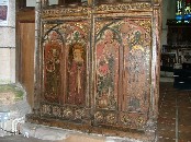 rood screen north: St Edmund with his arrow, St Clare with her book and habit, St Clement with his anchor and crozier, St James in his pilgrim's robes