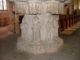 Figures on pedestal: Baptism (godparent)