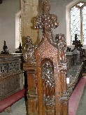 St Simon holds a fish in the niche; the sin above is Gluttony